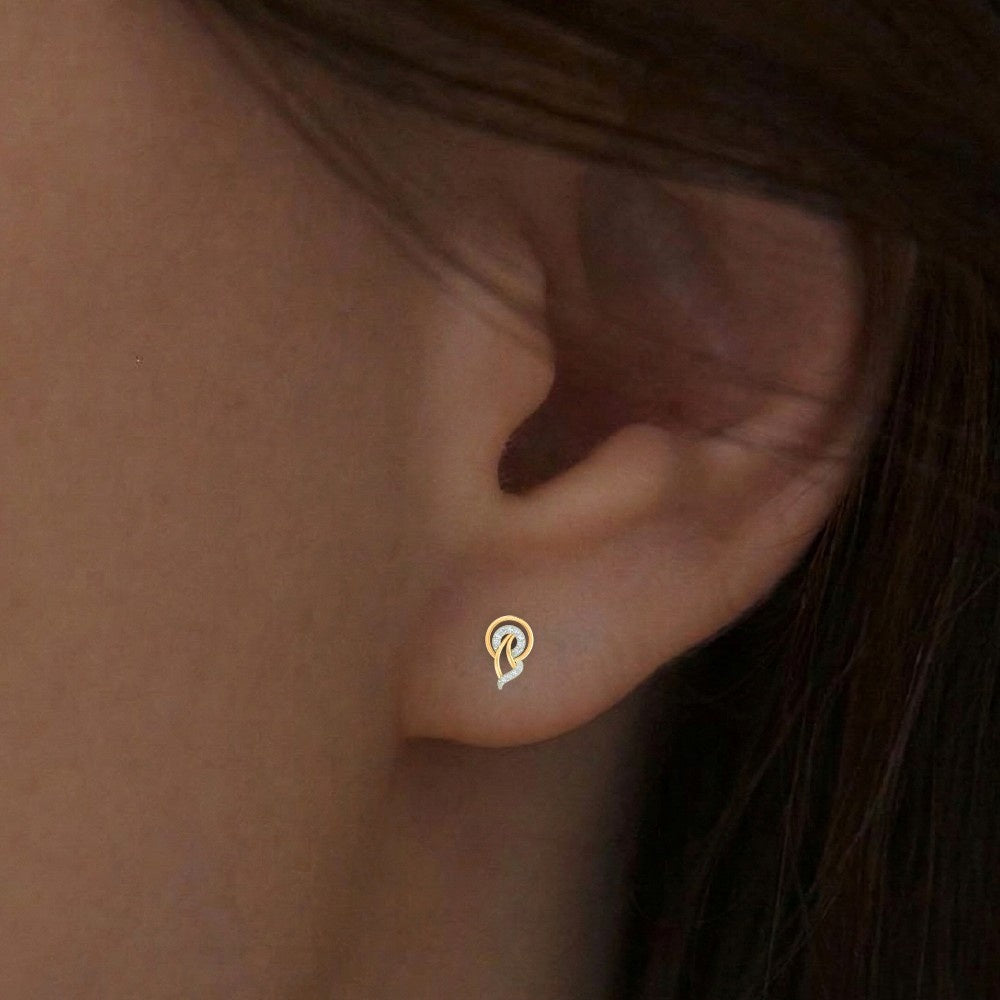 Close-up shot of a gold and diamond stud earrings.