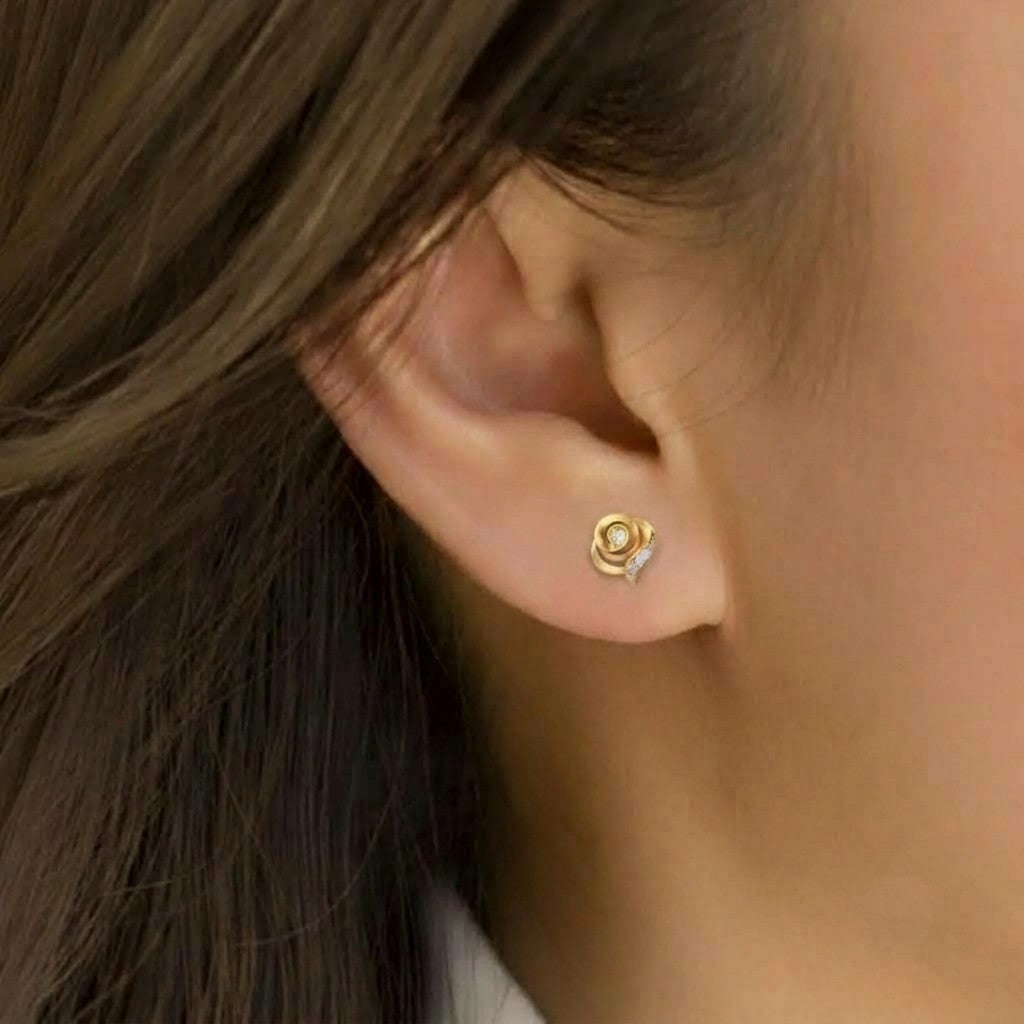 Gold and diamond stud earring on a person's ear 