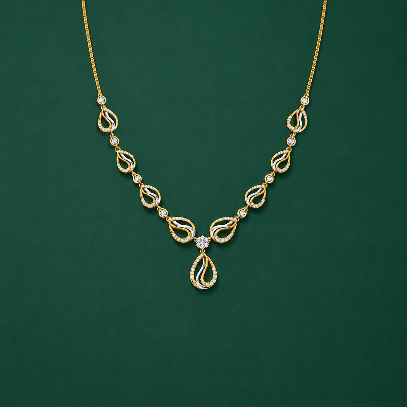 A gold necklace with a teardrop-shaped and repeating teardrop motifs, displayed on a solid dark green background.