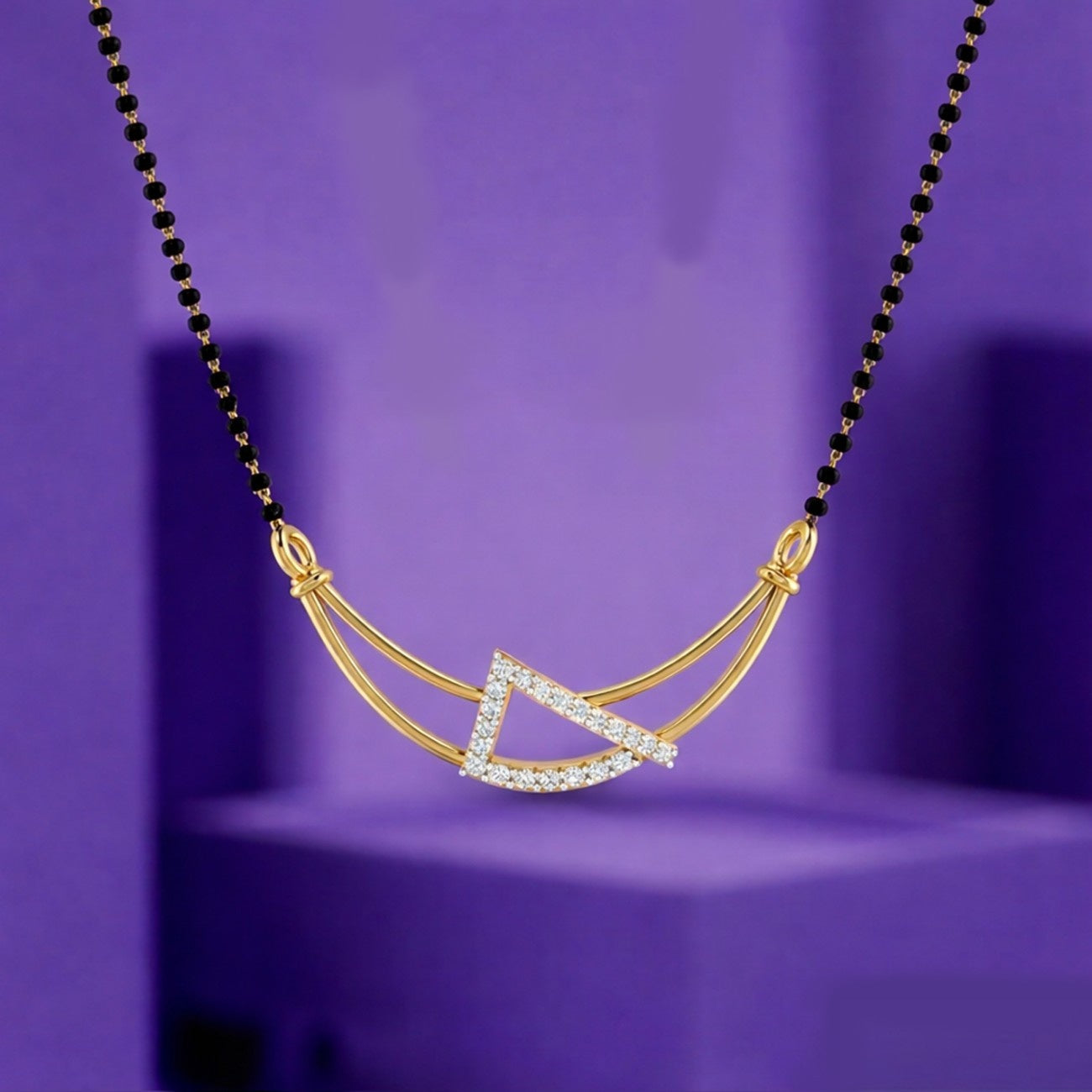 Yellow Gold and diamond mangalsutra on a purple background