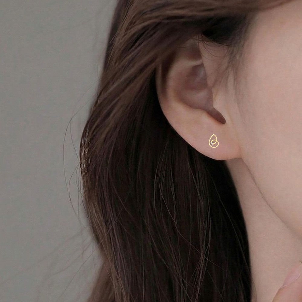 Close-up shot gold and diamond stud earring.