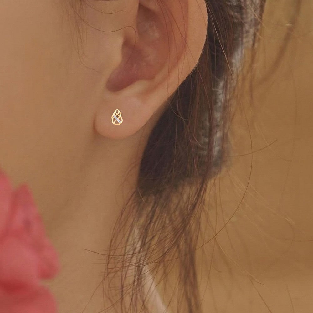 Close-up shot of a gold and diamond earring.