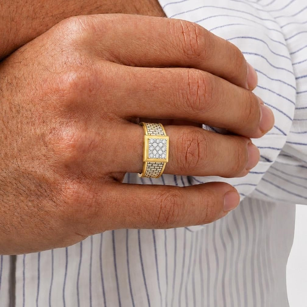 Gold ring with diamonds on a person's finger against a striped shirt background