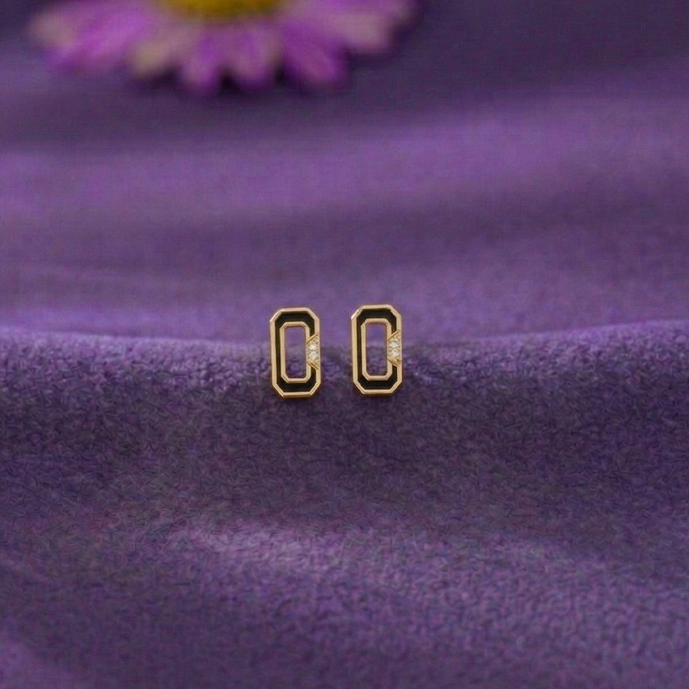 Gold and diamod stud earring on a surface.