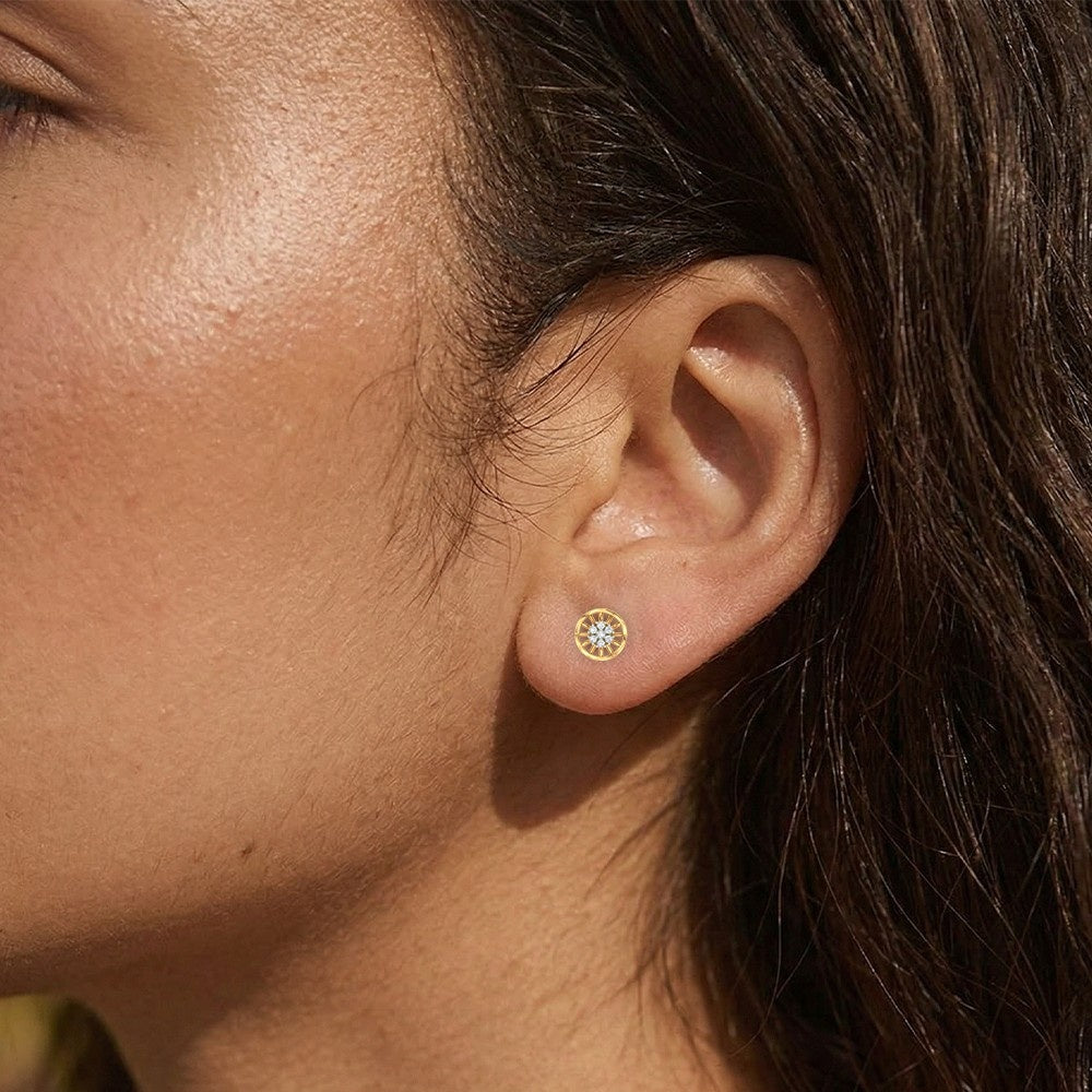 Close-up earring of a gold and diamond round-shaped earring.