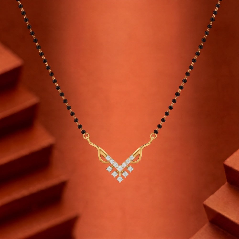 Gold and diamond mangalsutra with black beads on a brown background