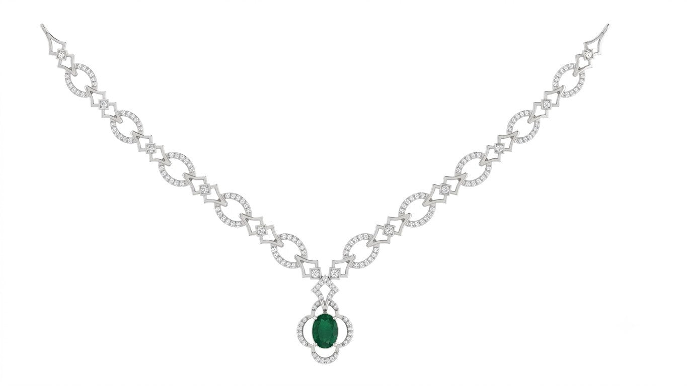 A white gold and diamond necklace with a central green emerald, displayed on a solid white background.