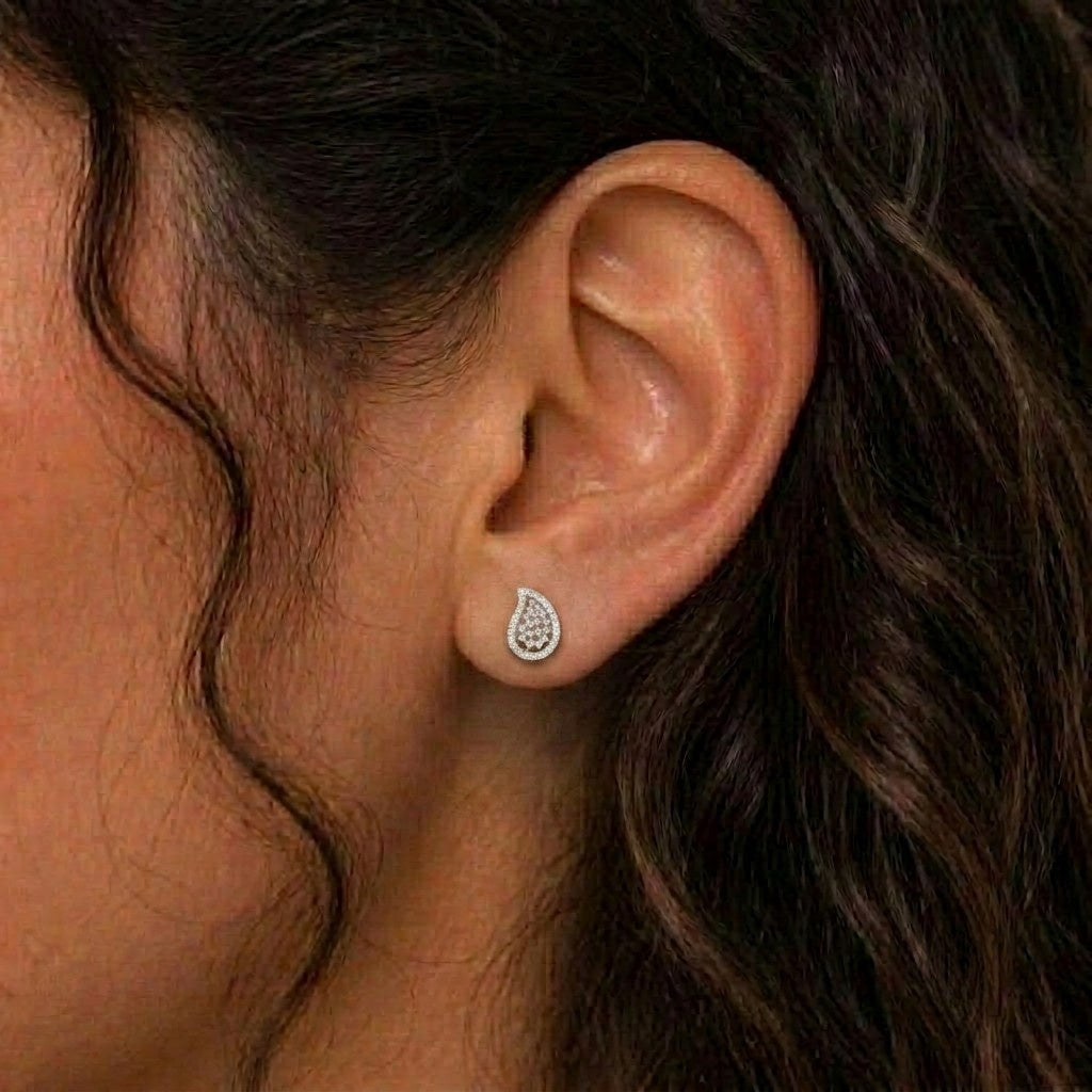 Close-up shot of a gold and diamond  teardrop earring.