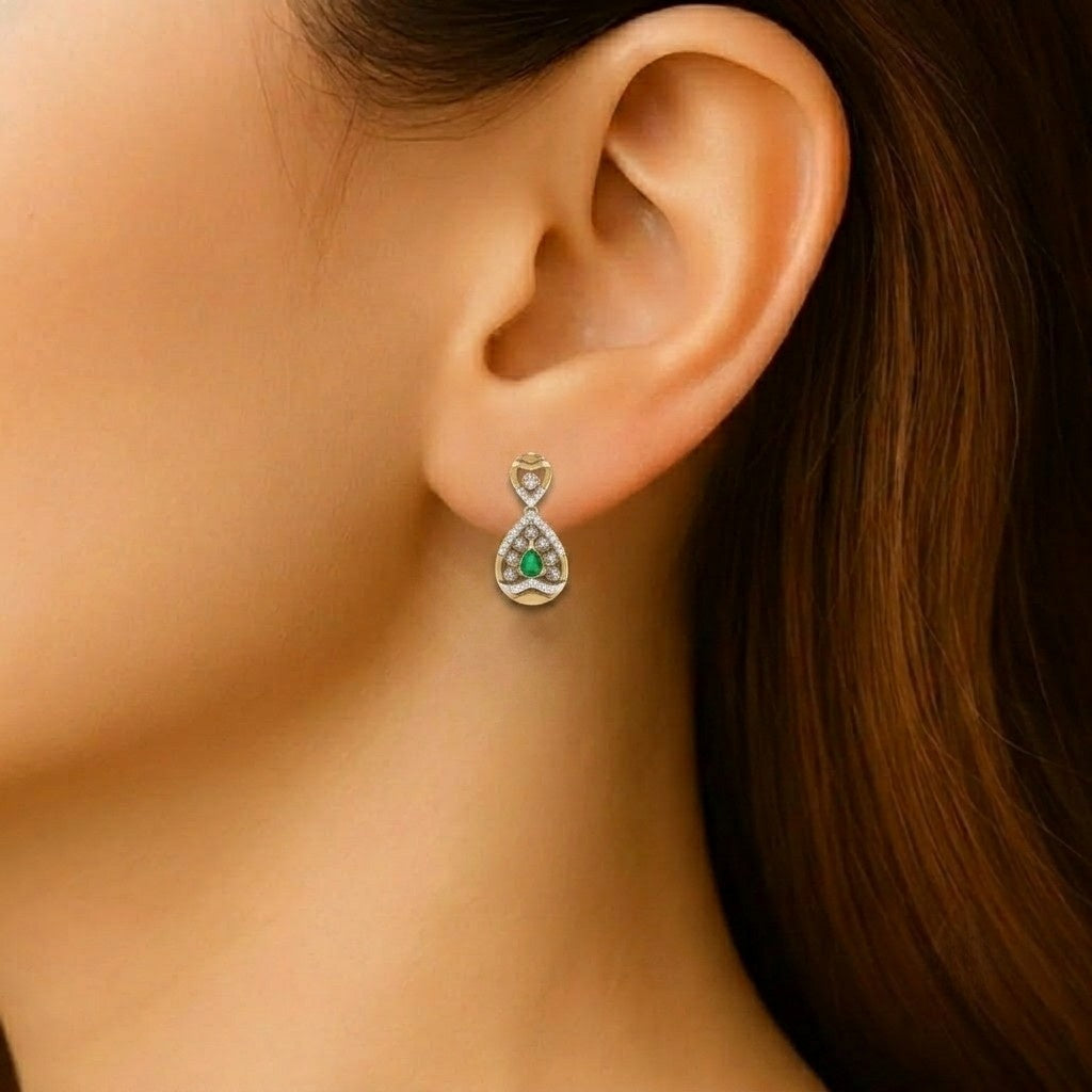 A close-up of a model's ear wearing a small teardrop earring