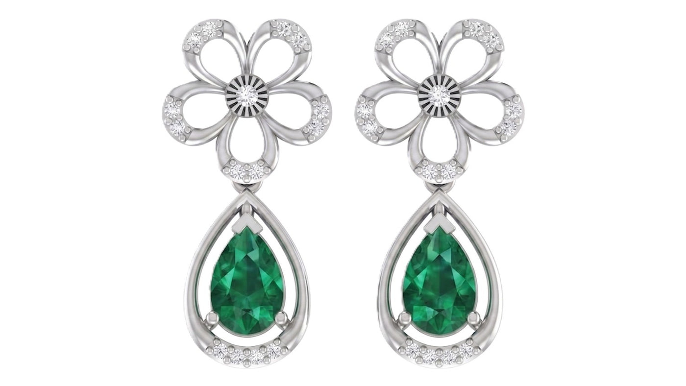 White Gold and diamond drop earrings with emerald gemstones on a white background