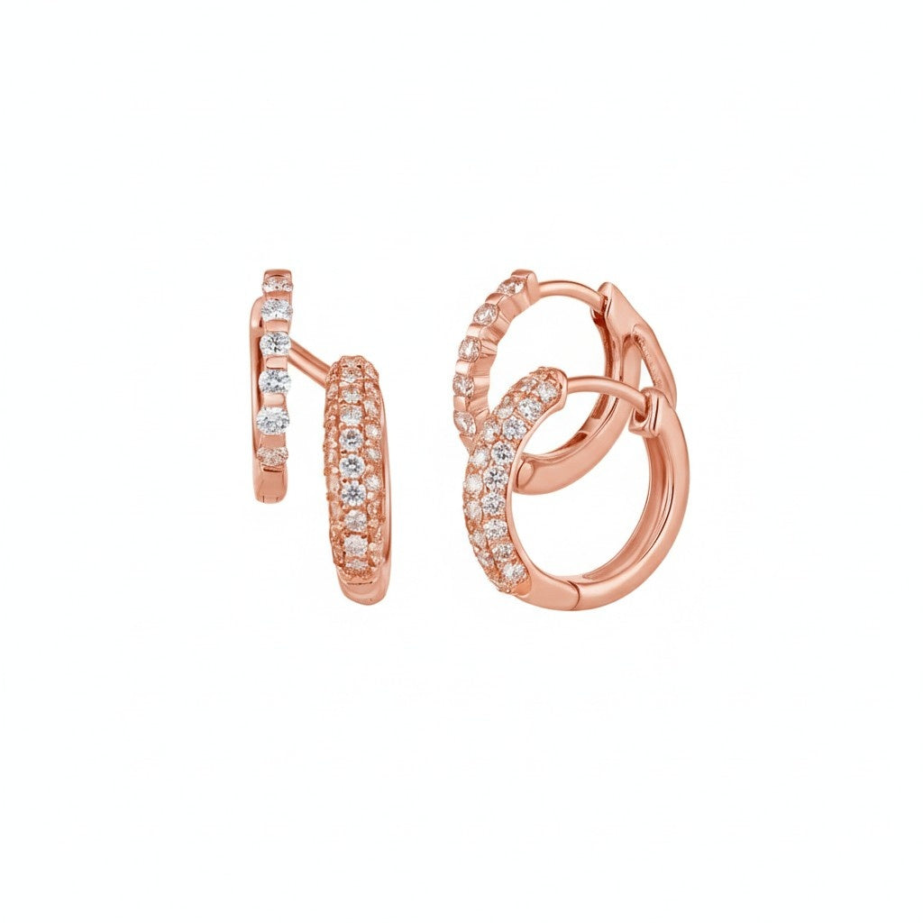 Rose gold hoop earrings with small diamonds on a white background

