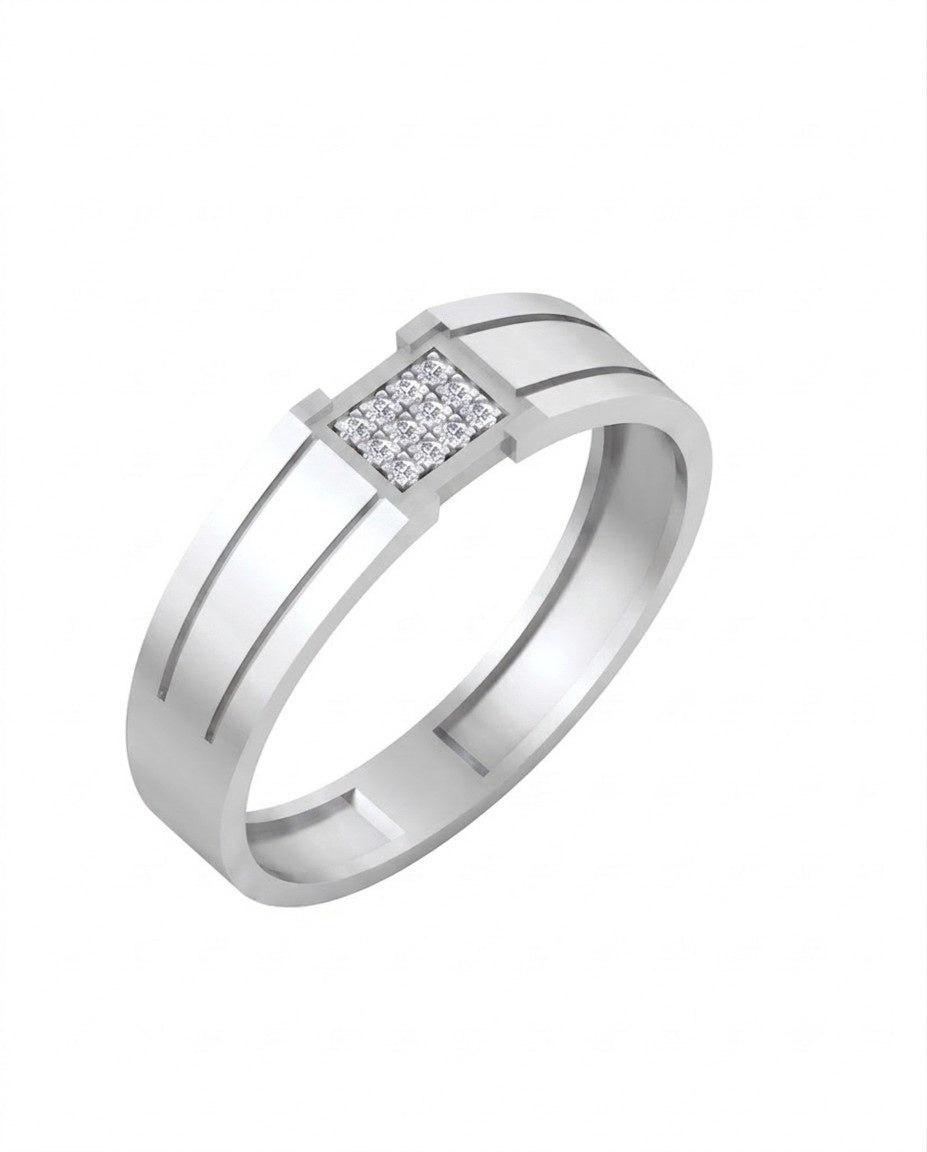 A white gold ring with a rectangular diamond setting, resting on a light beige marble surface.