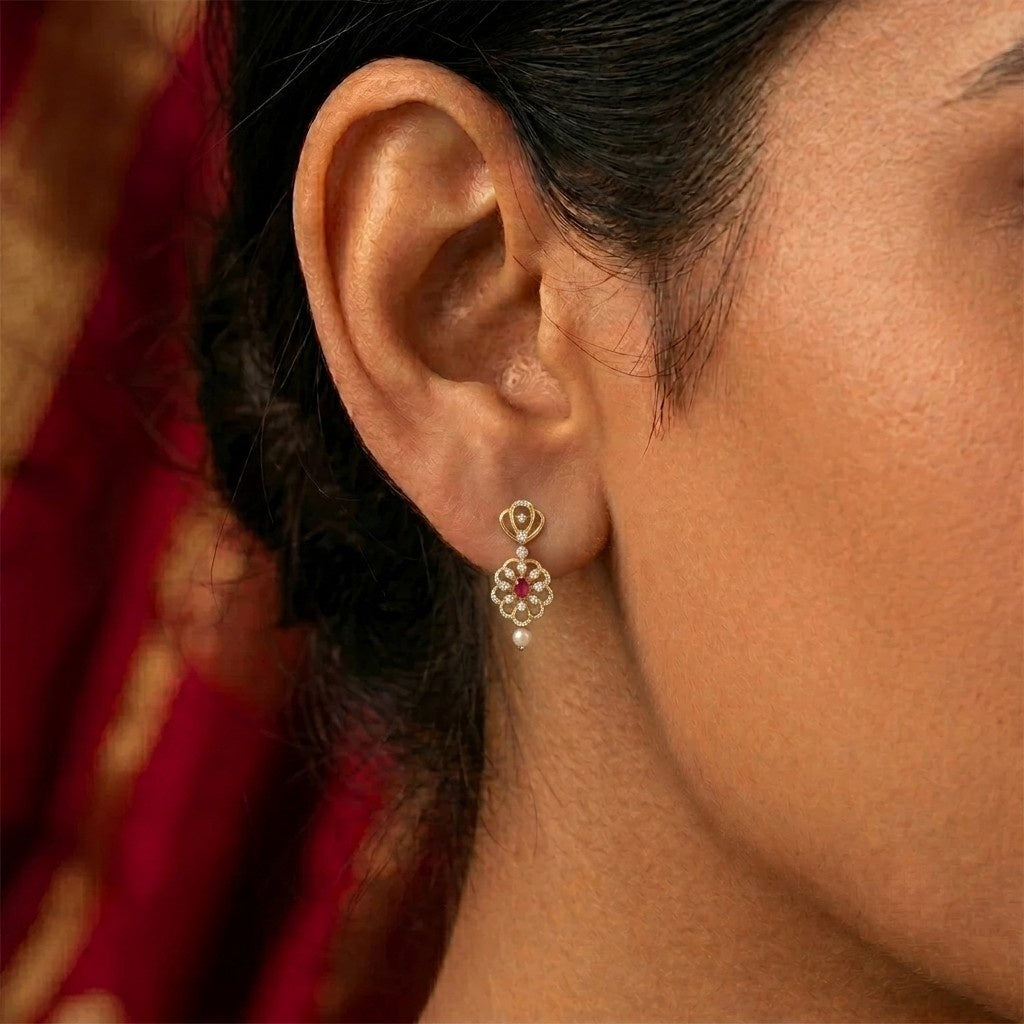 A close-up of a woman's ear wearing dangle earring.