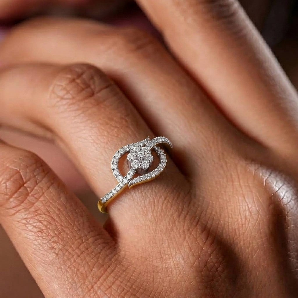 Gold and diamonds with floral cluster on a person's finger.