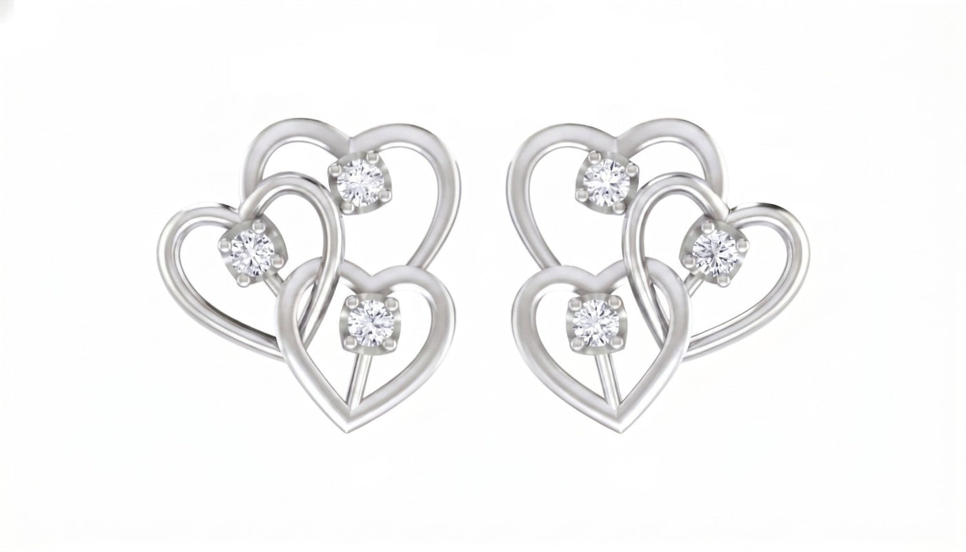 White gold and diamond heart-shaped earrings on a white background