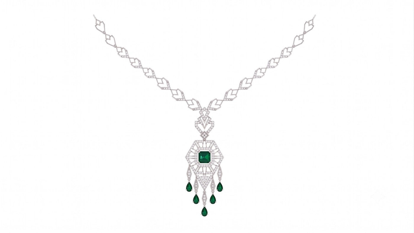 A white gold and diamond necklace featuring a central green emerald, set against a plain white background.