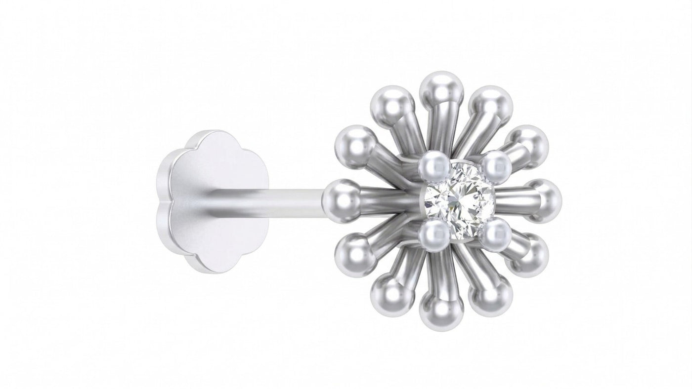 White gold and diamond stud nose pin with a central diamond and smaller pearls on a white background