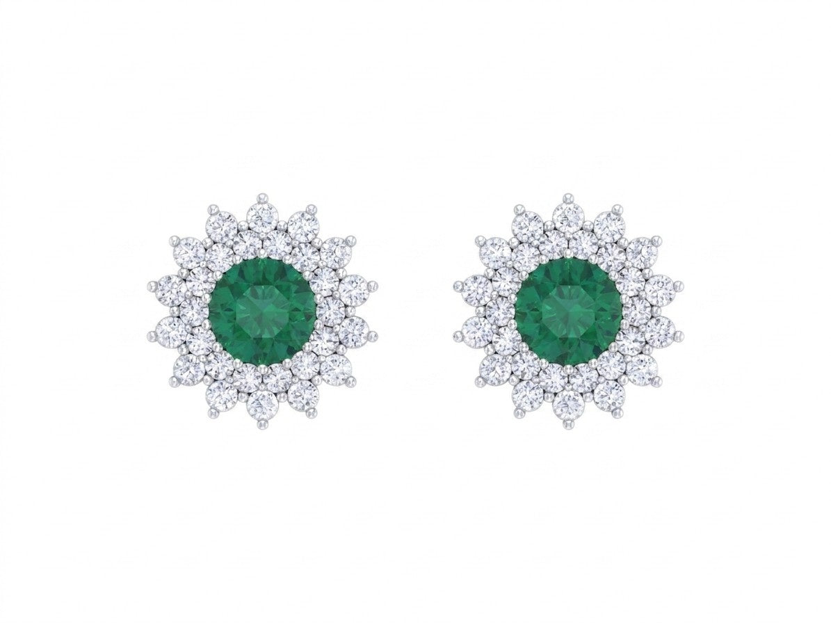 Pair of white gold and diamond stud earrings with emerald gemstone on a white background.