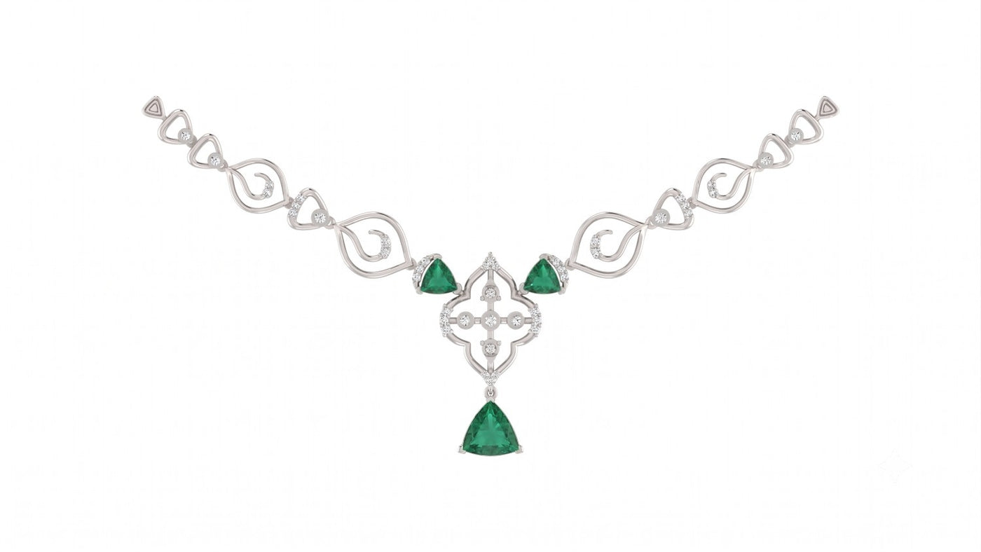 White gold and diamond necklace with three trillion-cut emeralds, diamond accents, and floral-design.