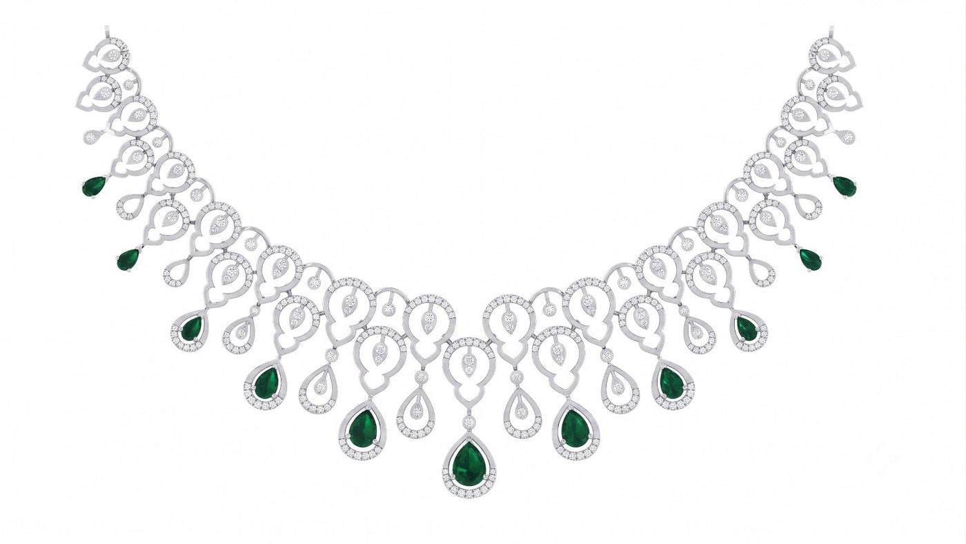 A white gold necklace with emerald teardrop gemstone, displayed on a solid white background.
