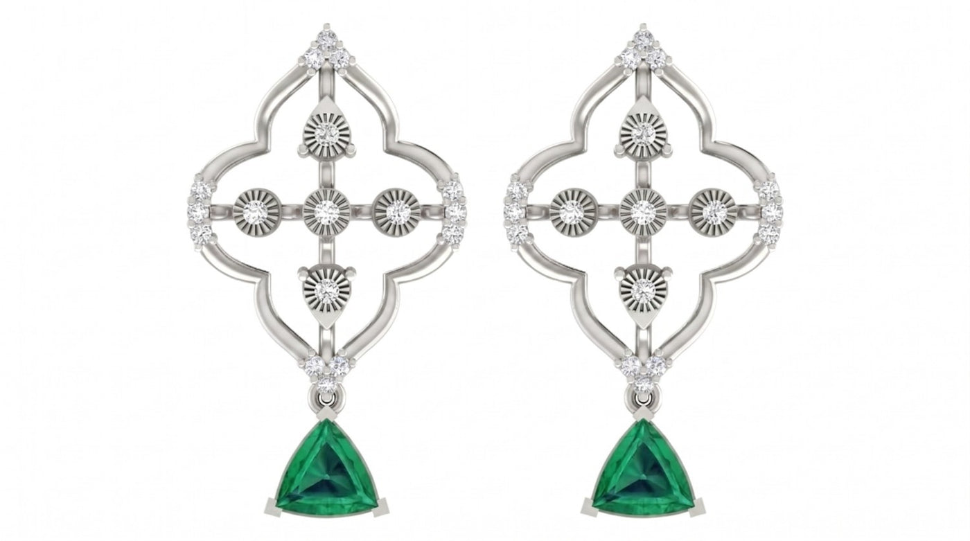 White gold and diamond drop earrings with emerald gemstones on a white background