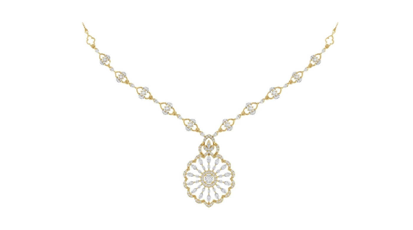 Yellow gold and diamond necklace on a white background