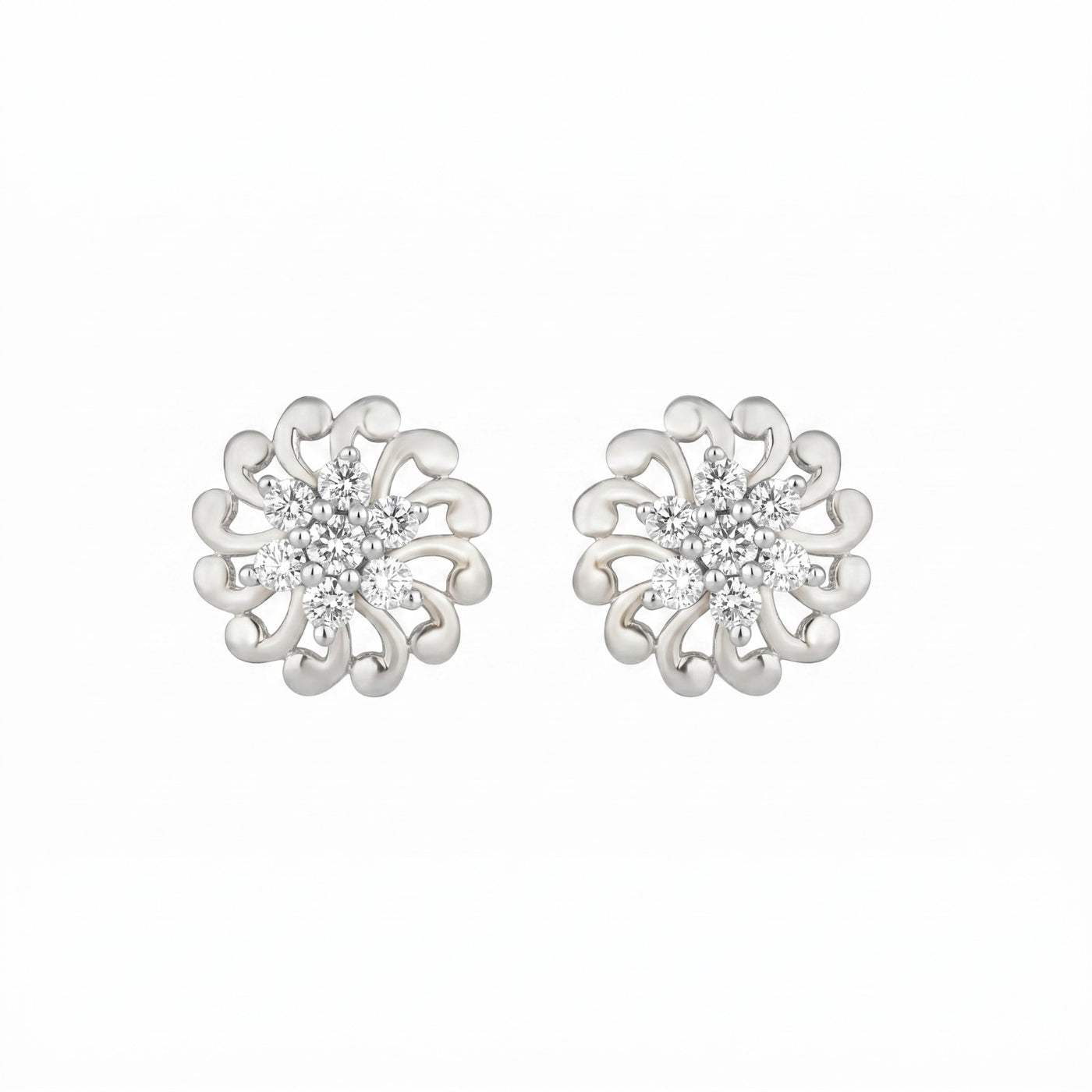 White gold floral earrings with diamond center on a white background

