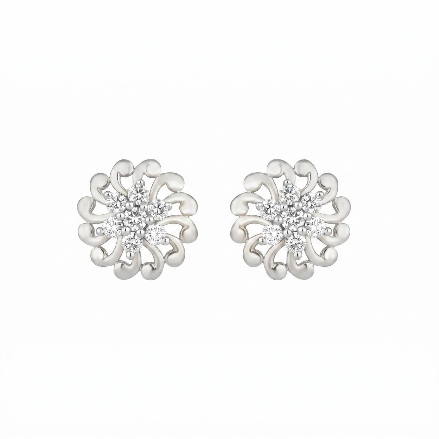 White gold floral earrings with diamond center on a white background.