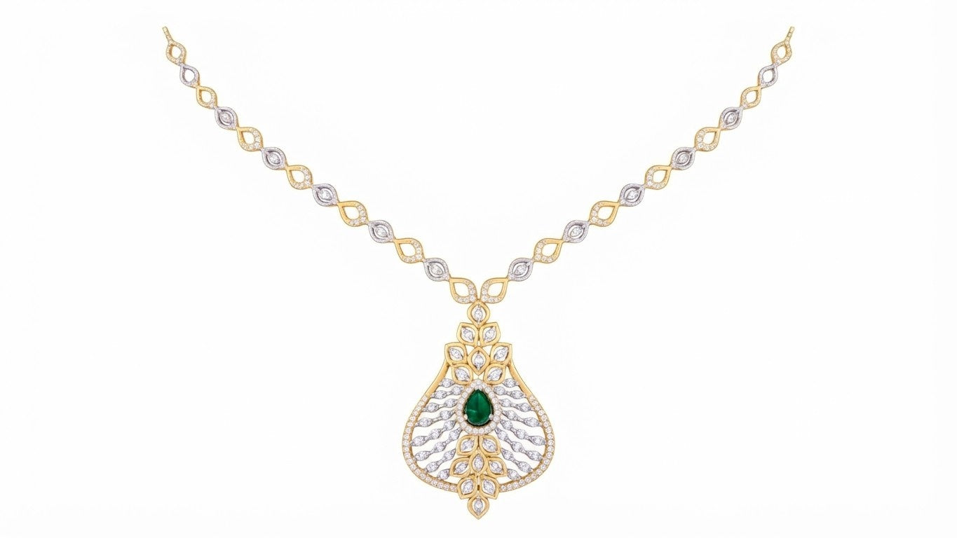 A yellow gold and diamond necklace featuring a teardrop-shaped pendant with a central green emerald and clear pavé stones, displayed on a solid white background.