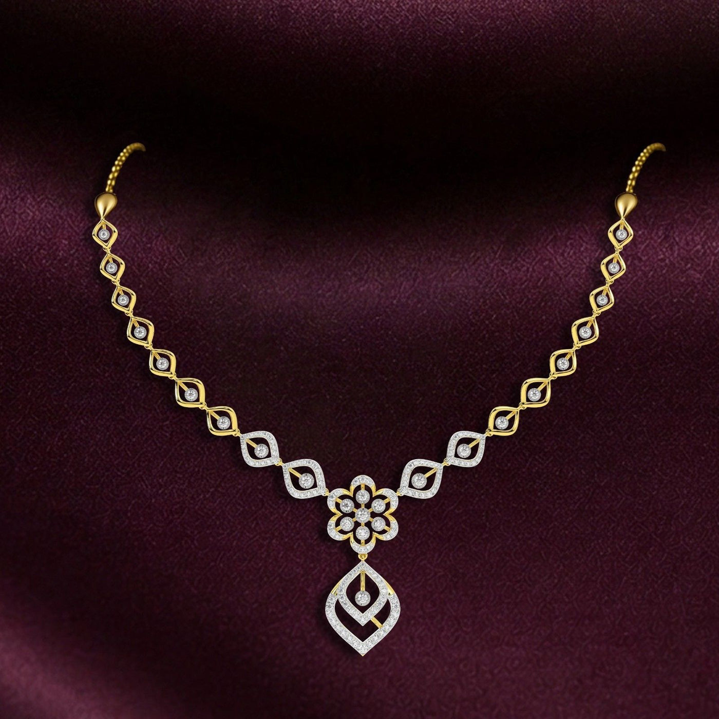 Gold and diamond necklace on a dark purple background.