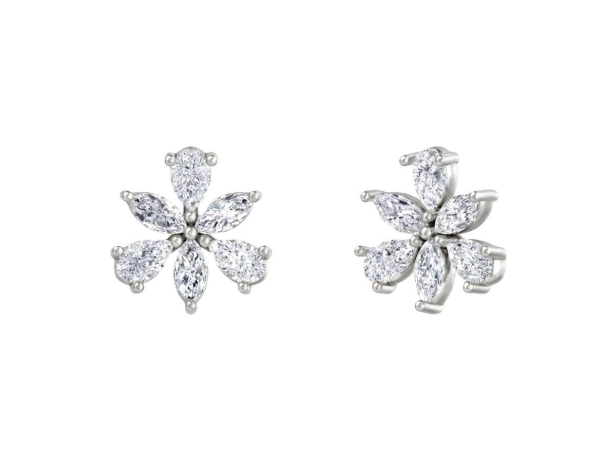 White gold and diamond flower-shaped earrings on a white background