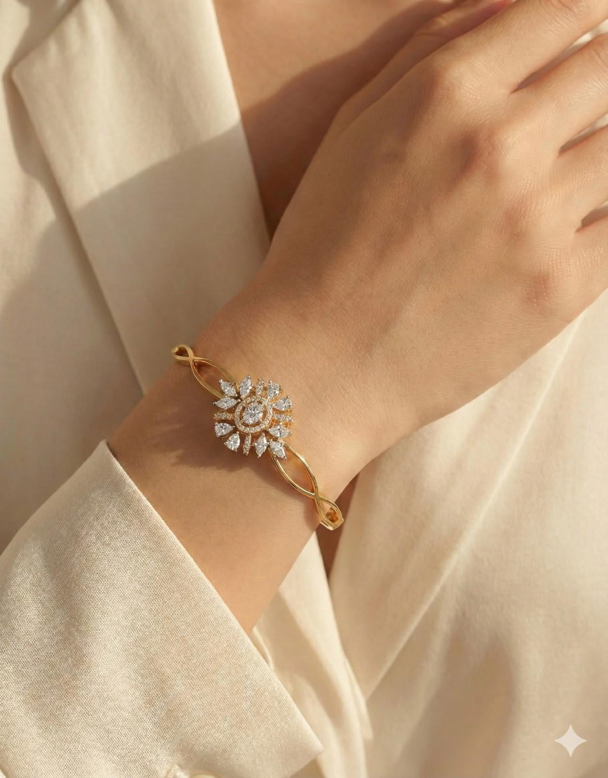 Yellow Gold bangle bracelet with diamond cluster centerpiece in starburst design, featuring twisted band detail and safety clasp.