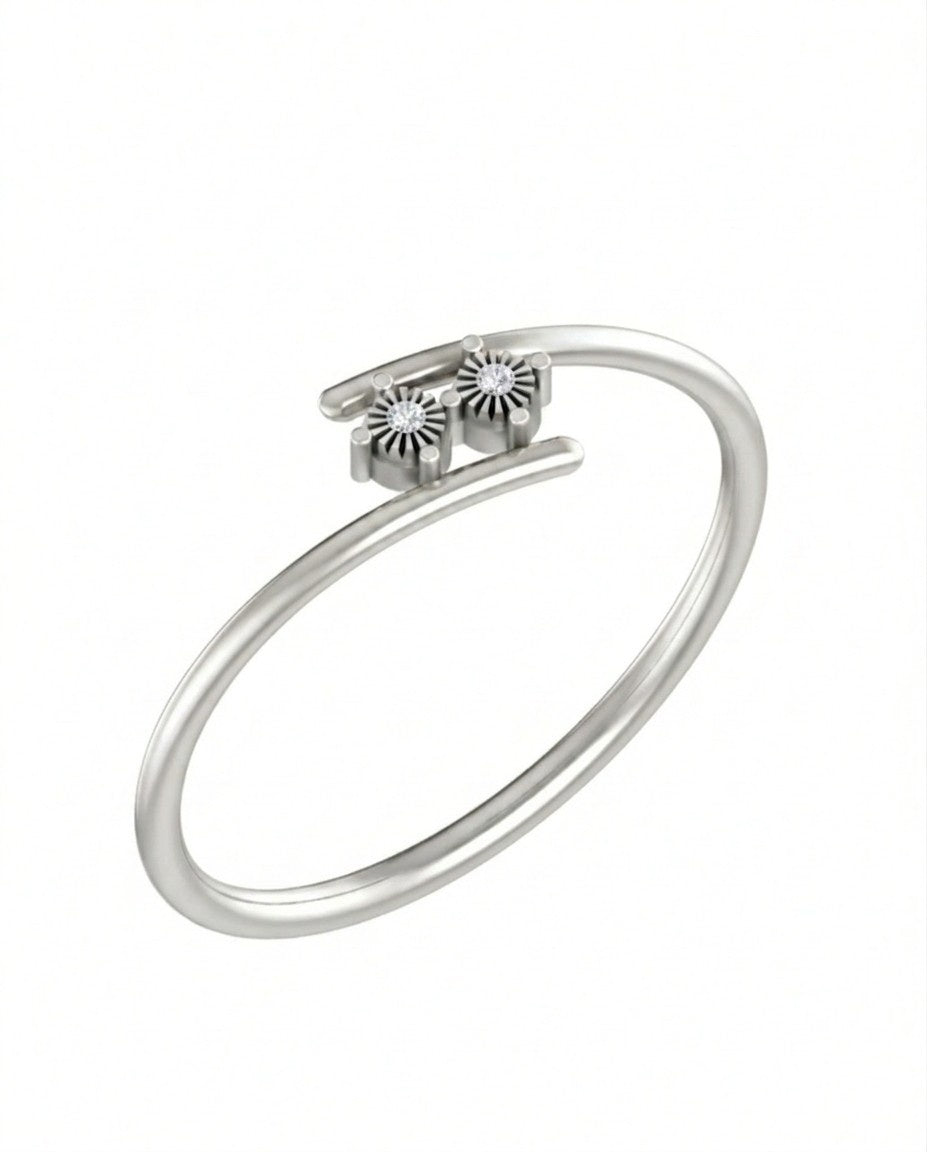 White gold ring with diamond charms on a white background