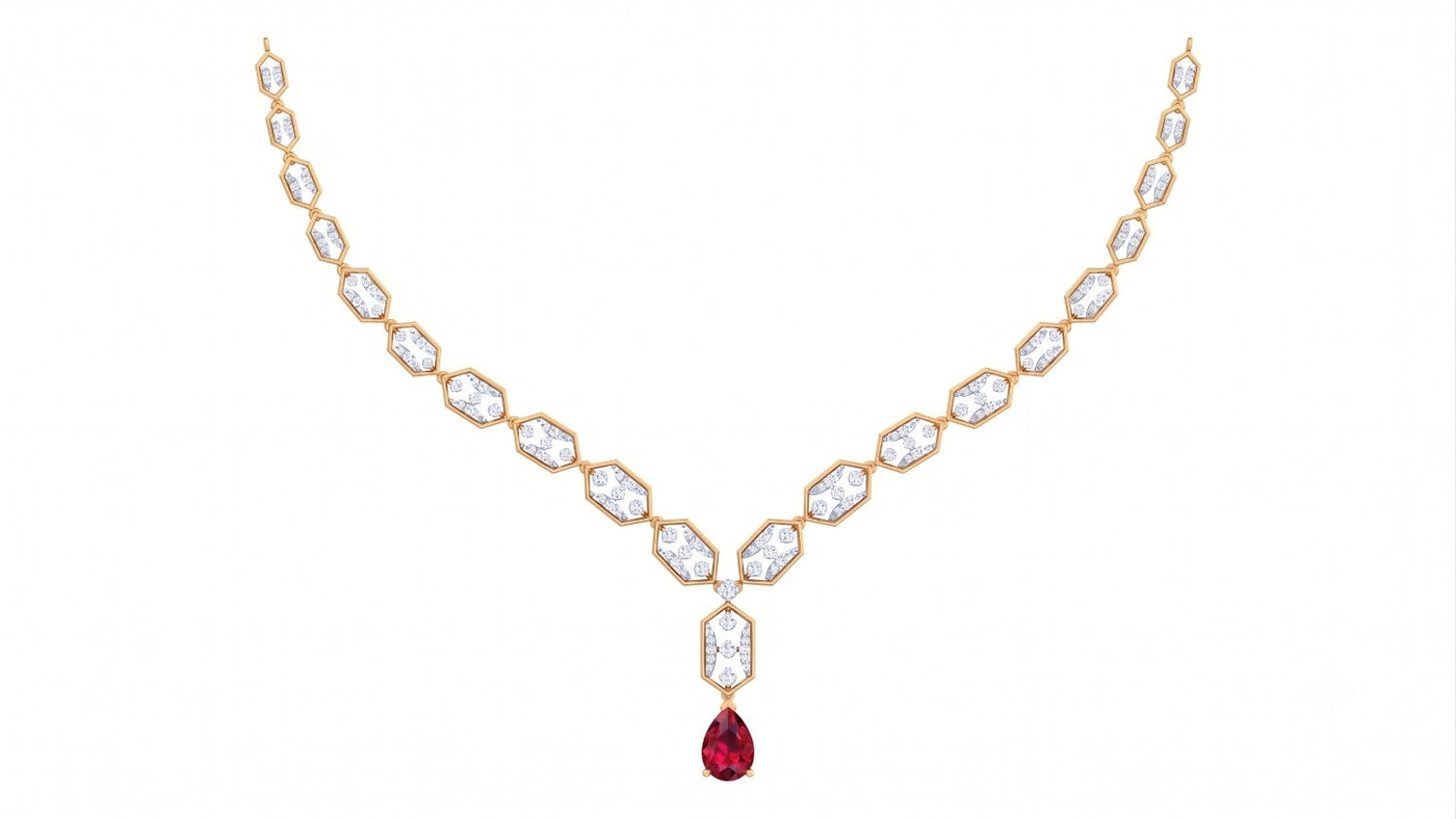 A yellow gold Y-shaped necklace featuring a gemstones and a teardrop-shaped red ruby, displayed on a solid white background.