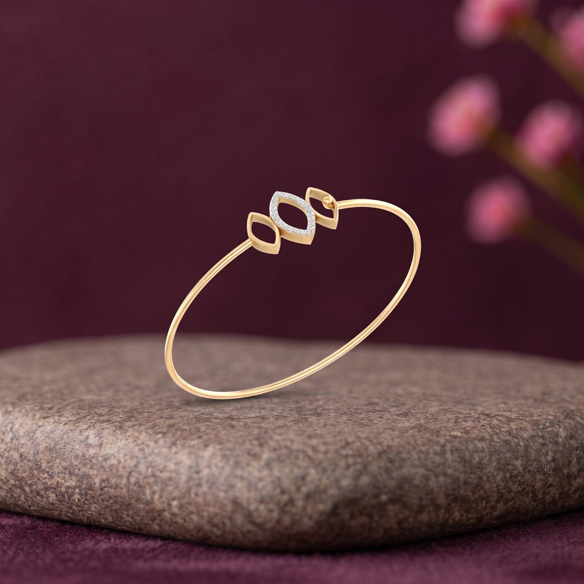 Gold diamond bracelet with elegant marquise geometric design on a surface.
