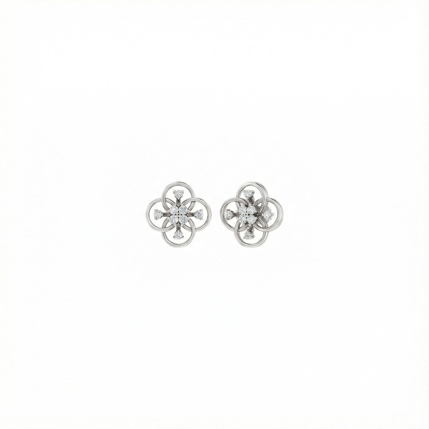 Pair of white gold flower-shaped earrings with diamond-like stones on a white background