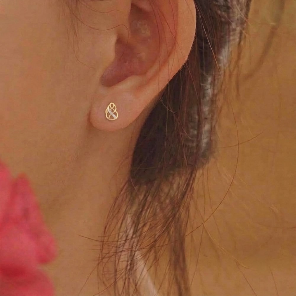 Close-up shot of a gold and diamond earring.