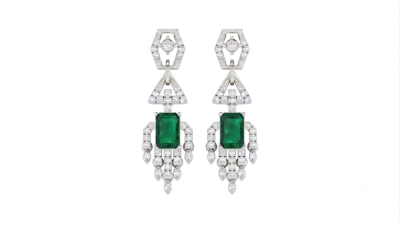 A pair of white gold and diamond dangler earrings with rectangular green emerald-cut center stones, shown against a plain white background.