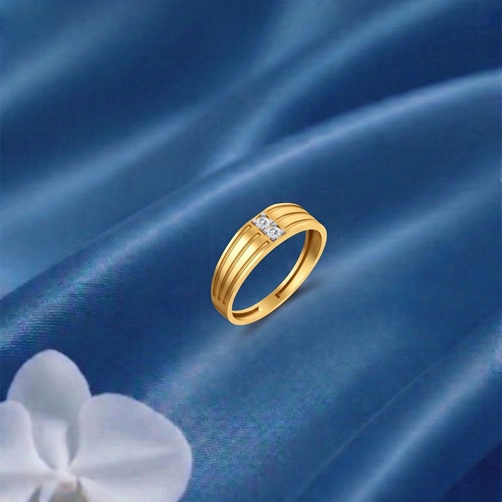 Gold ring with diamonds on a blue satin background.