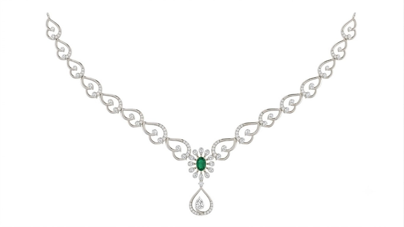 White gold necklace with a central green emerald and diamond floral motif, featuring a teardrop-shaped diamond, set against a plain white background.