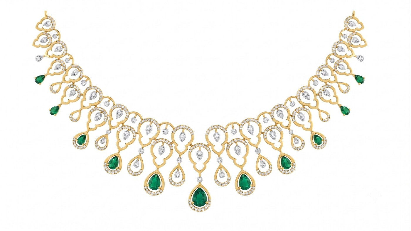 A yellow gold necklace with emerald teardrop gemstone, displayed on a solid white background.