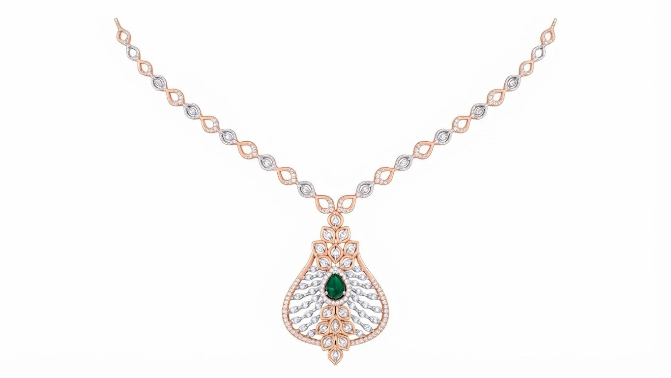 A rose gold and diamond necklace featuring a teardrop-shaped pendant with a central green emerald and clear pavé stones, displayed on a solid white background.