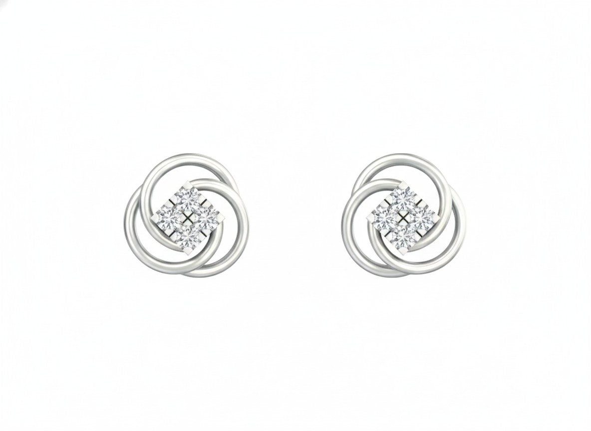 White gold and diamond floral stud earrings on a white background.