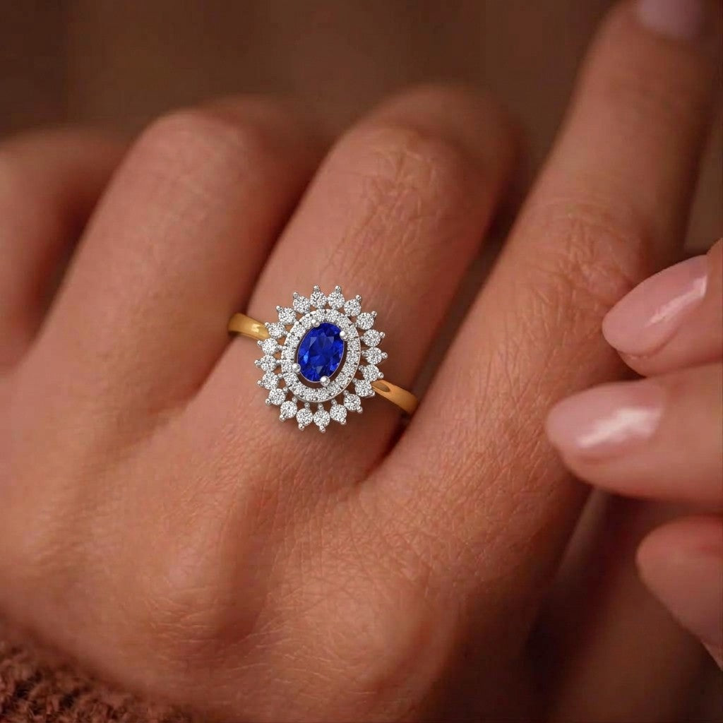 Gold ring with a blue gemstone and diamond halo on a hand