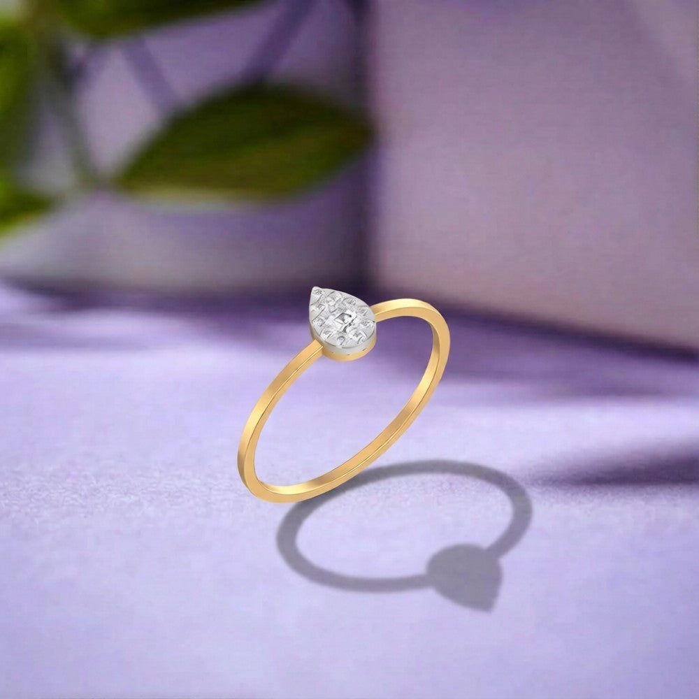 Gold and diamond with teardrop shaped cluster setting on purple fabric.