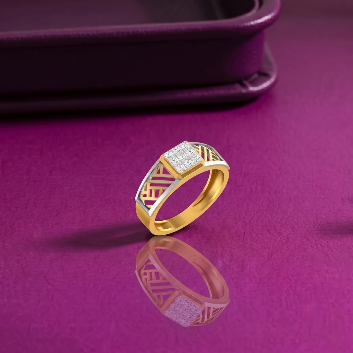 A gold ring with a square diamond-set center and geometric openwork detailing on the band, displayed on a purple surface.