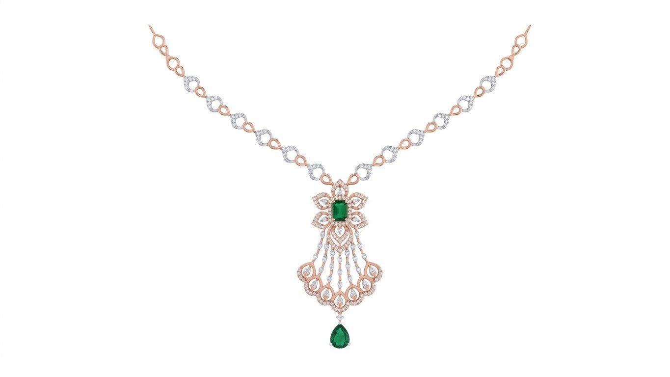 A rose gold and diamond necklace with a central floral design featuring green emerald-cut gemstones shown on a plain white background.