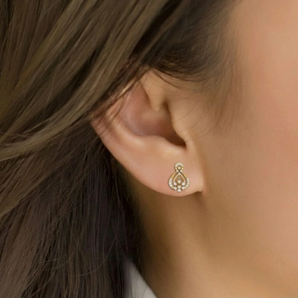 Close-up of an ear wearing a gold and diamond earring.