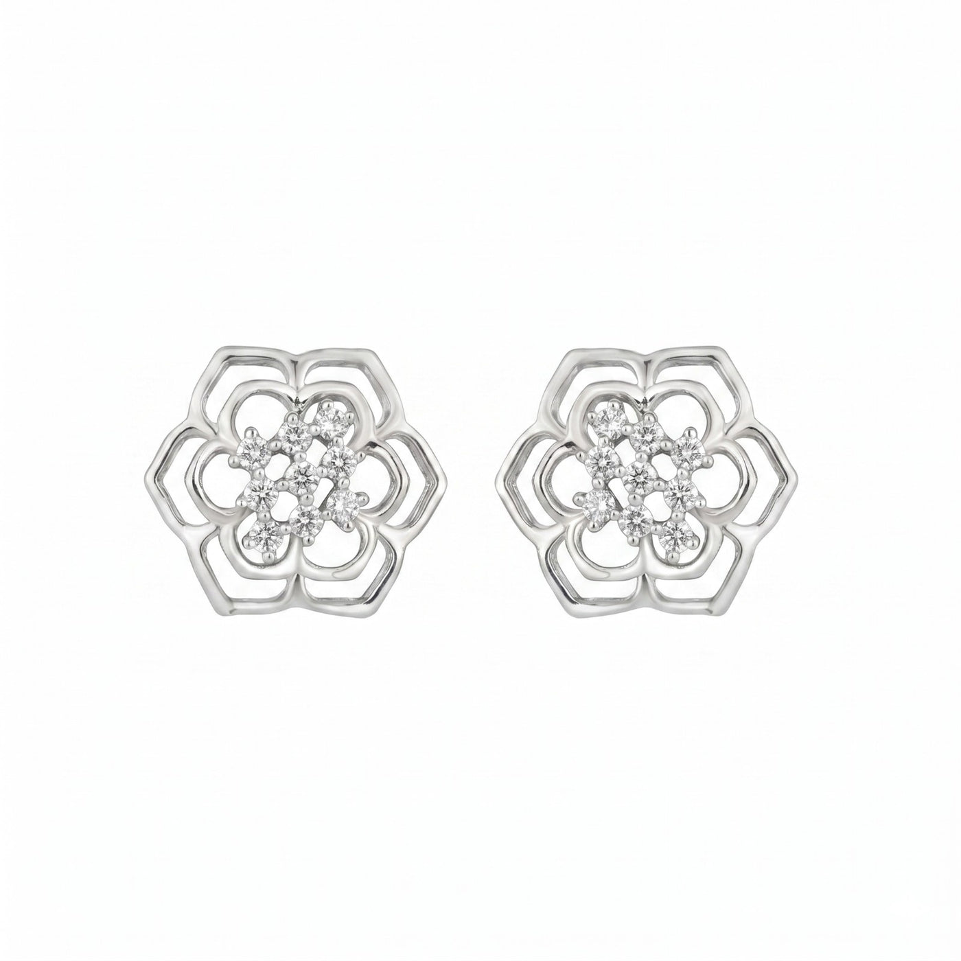 White gold floral earrings with diamond accents on a white background