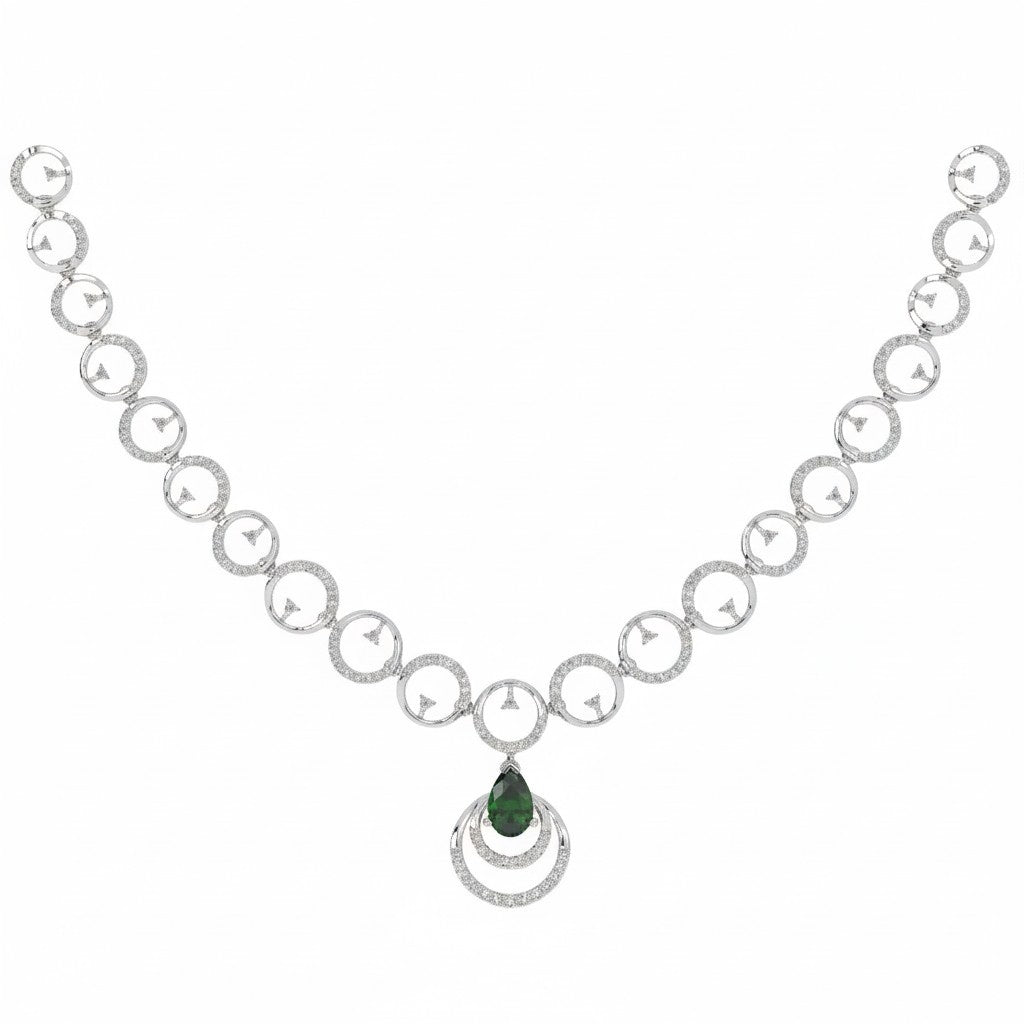 A white gold necklace featuring alternating diamond-accented circular links and a central pear-shaped deep green gemstone pendant on a white background
